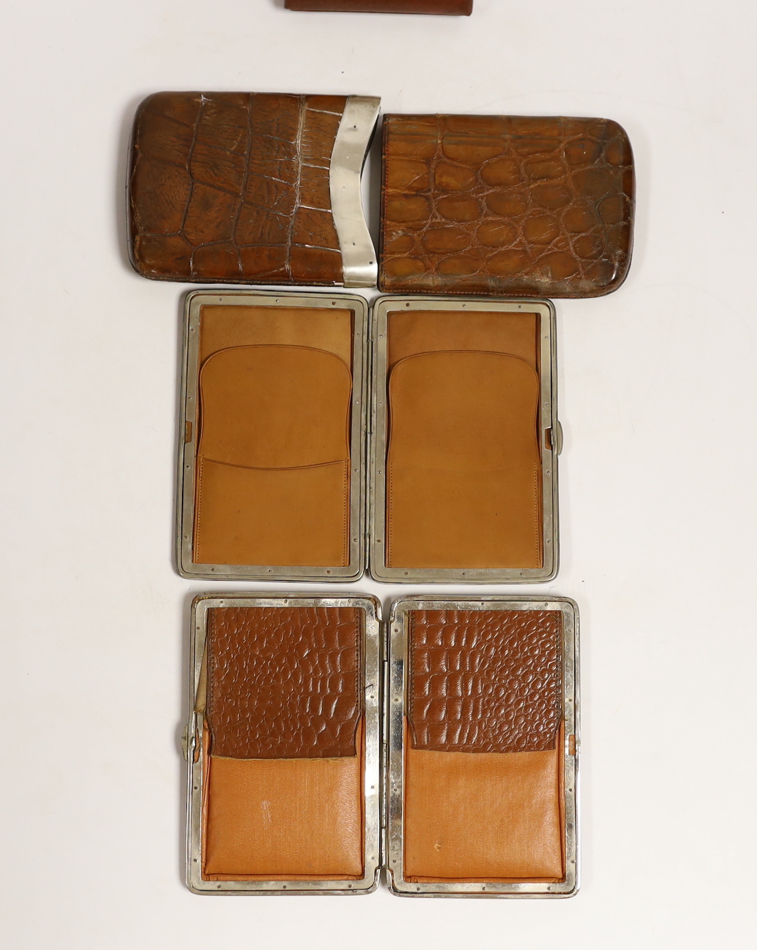 A silver-mounted leather cigar case and two others, together with a box of five Corona cigars.